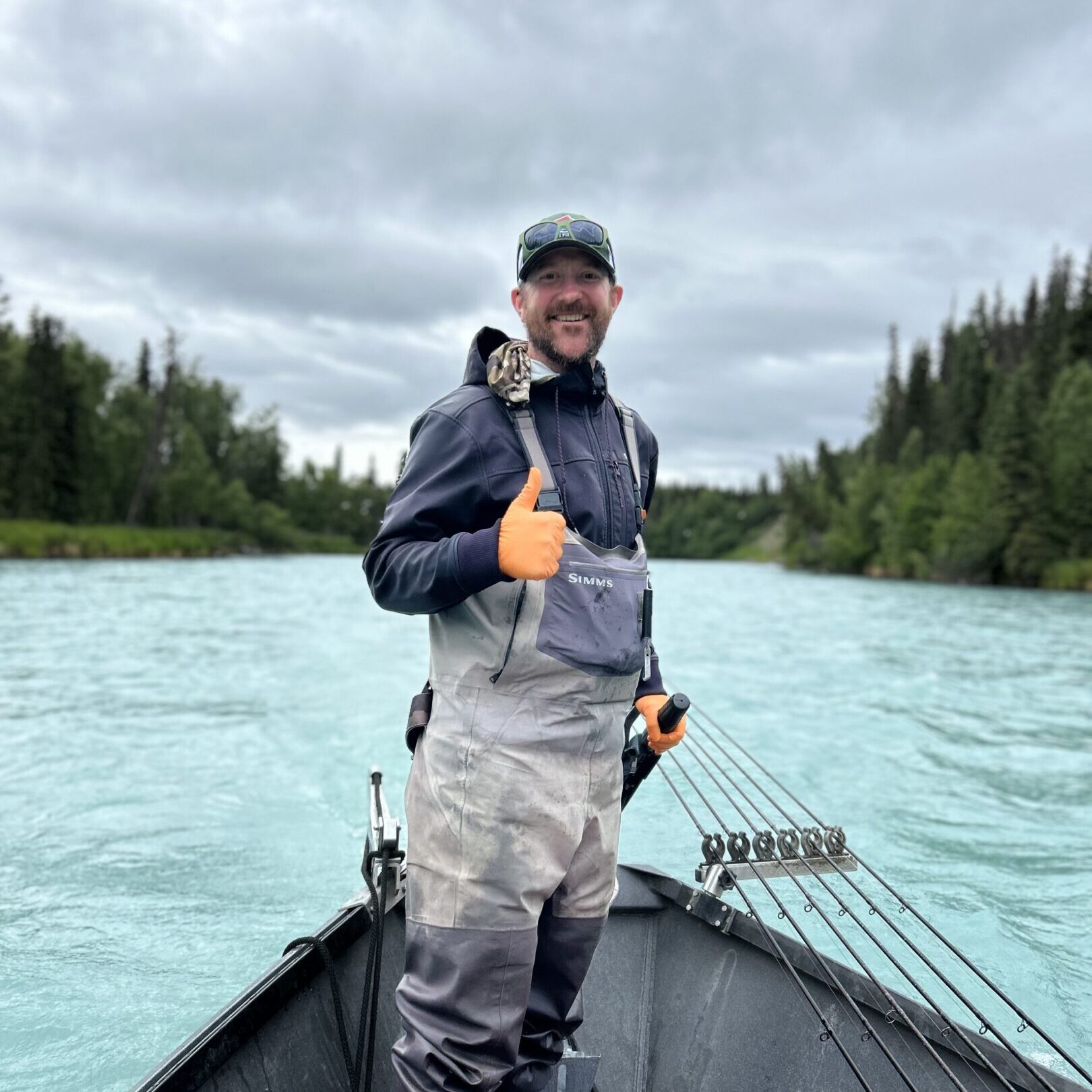 Smiling fisherman with fishing rods